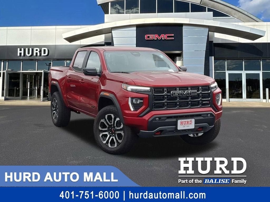 2026 GMC Canyon AT4 in Volcanic Red Tintcoat — front three-quarter view